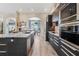 Modern kitchen with sleek cabinets, stainless steel appliances, and a center island with countertop at 907 Ridge Spring Ct, Apopka, FL 32712