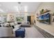 Bright living room featuring a comfortable sectional sofa, skylights, and modern decor at 907 Ridge Spring Ct, Apopka, FL 32712