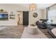 Cozy living space with a stylish barn door, decorative shelving, and wood-look tile flooring at 907 Ridge Spring Ct, Apopka, FL 32712