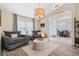 Comfortable living room with a large window, stylish decor, and wood-look tile flooring at 907 Ridge Spring Ct, Apopka, FL 32712
