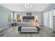 Comfortable primary bedroom featuring an elegant chandelier, accent lamps, and two large sunlit windows at 907 Ridge Spring Ct, Apopka, FL 32712