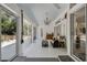 Bright sunroom with tile floors, chandelier, wet bar, and sliding doors to the patio at 907 Ridge Spring Ct, Apopka, FL 32712