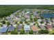 Aerial neighborhood view shows many homes, tree-lined streets, and a tranquil lake at 9076 Lake Avon Dr, Orlando, FL 32829