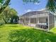 A beautiful screened lanai sits in the backyard with a jacuzzi and ample space for seating at 9076 Lake Avon Dr, Orlando, FL 32829