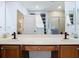 Bathroom featuring double vanity, walk-in shower, soaking tub and closet view in mirror at 9076 Lake Avon Dr, Orlando, FL 32829
