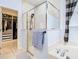 Walk-in shower with glass enclosure and separate soaking tub and walk-in closet at 9076 Lake Avon Dr, Orlando, FL 32829