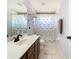Bathroom featuring a vanity and a shower/tub combo with a colorful shower curtain at 9076 Lake Avon Dr, Orlando, FL 32829