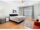 Spacious bedroom featuring hardwood floors, a ceiling fan, and a large window at 9076 Lake Avon Dr, Orlando, FL 32829