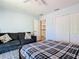 Serene bedroom featuring a comfortable bed, a cozy sofa, and ample closet space at 9076 Lake Avon Dr, Orlando, FL 32829