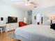 Bedroom with hardwood floors, ceiling fan, and adjacent walk-in closet at 9076 Lake Avon Dr, Orlando, FL 32829
