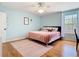 Inviting bedroom with pink details, wood flooring, and a ceiling fan for added comfort at 9076 Lake Avon Dr, Orlando, FL 32829