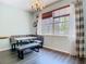 Eat-in kitchen area featuring a banquette, a chandelier, large window and sleek wood flooring at 9076 Lake Avon Dr, Orlando, FL 32829