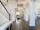 Spacious foyer with hardwood floors, arches, and stairway leading to the upper level at 9076 Lake Avon Dr, Orlando, FL 32829