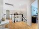 Open hallway with wood floors and white railings, leading to bedrooms and living areas at 9076 Lake Avon Dr, Orlando, FL 32829