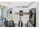 Modern kitchen with granite countertops, stainless appliances, and breakfast bar at 9076 Lake Avon Dr, Orlando, FL 32829
