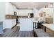Well-equipped kitchen with stainless steel appliances, granite countertops, breakfast bar, and white cabinets at 9076 Lake Avon Dr, Orlando, FL 32829