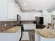 Bright kitchen with white cabinets, granite countertops, mosaic backsplash, and stainless steel appliances at 9076 Lake Avon Dr, Orlando, FL 32829