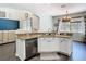 Gourmet kitchen featuring a center island with sink, stainless steel appliances and granite countertops at 9076 Lake Avon Dr, Orlando, FL 32829