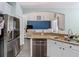 Modern kitchen with stainless steel appliances, granite countertops, and an open concept design at 9076 Lake Avon Dr, Orlando, FL 32829