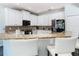 Modern kitchen with granite countertops, stainless steel appliances, breakfast bar and pendant lights at 9076 Lake Avon Dr, Orlando, FL 32829