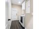 Bright laundry room with white cabinets and modern washer and dryer appliances at 9076 Lake Avon Dr, Orlando, FL 32829