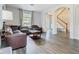 Cozy living room with hardwood floors, a comfortable leather sofa, and a view of the foyer at 9076 Lake Avon Dr, Orlando, FL 32829