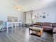 Comfortable living room featuring hardwood floors, a ceiling fan, and a large window at 9076 Lake Avon Dr, Orlando, FL 32829
