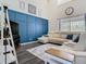 Comfortable living room with a blue accent wall and plush sectional sofa at 9076 Lake Avon Dr, Orlando, FL 32829