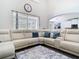 Bright living room showcasing stylish sectional and view to kitchen at 9076 Lake Avon Dr, Orlando, FL 32829