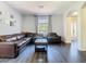 Open-concept living room with hardwood floors and plenty of space for entertaining guests at 9076 Lake Avon Dr, Orlando, FL 32829