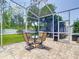 Covered patio with a table and chairs offering scenic backyard views and ample natural light at 9076 Lake Avon Dr, Orlando, FL 32829