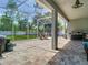 Covered outdoor patio with a dining area and barbecue setup for outdoor enjoyment at 9076 Lake Avon Dr, Orlando, FL 32829