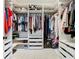 Custom walk-in closet featuring plenty of shelving and hanging space at 9076 Lake Avon Dr, Orlando, FL 32829