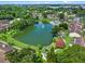 Aerial view of a community with a pool, a tennis court, a lake with a fountain, and green landscaping at 11 Escondido Cir # 110, Altamonte Springs, FL 32701