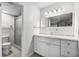 Bathroom with shower, tile floor, and vanity with white cabinets at 11 Escondido Cir # 110, Altamonte Springs, FL 32701