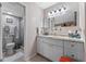 Clean bathroom with a walk-in shower and granite countertops at 11 Escondido Cir # 110, Altamonte Springs, FL 32701