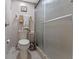 Cozy bathroom featuring a toilet, frosted glass shower, towel rack, and wall decorations at 11 Escondido Cir # 110, Altamonte Springs, FL 32701