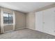 Bedroom with plush carpet, natural light from a window, and closet space at 11 Escondido Cir # 110, Altamonte Springs, FL 32701