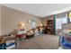 Spacious bedroom featuring a carpeted floor, side tables with lamps, a bookcase and decorations at 11 Escondido Cir # 110, Altamonte Springs, FL 32701