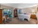 Comfortable bedroom featuring a sliding glass door to a sunroom and a cozy decor at 11 Escondido Cir # 110, Altamonte Springs, FL 32701