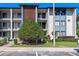 Attractive three-story condo building featuring balconies and a brick accent wall at 11 Escondido Cir # 110, Altamonte Springs, FL 32701