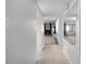 Hallway view leading to a living room featuring neutral colors, carpet and a brick fireplace at 11 Escondido Cir # 110, Altamonte Springs, FL 32701