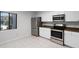 Kitchen with white cabinets, stainless steel appliances, a window and neutral countertops at 11 Escondido Cir # 110, Altamonte Springs, FL 32701