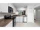 Modern kitchen features white cabinets, stainless steel appliances and tile floor at 11 Escondido Cir # 110, Altamonte Springs, FL 32701