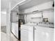 Well-equipped laundry room with washer, dryer, water heater and storage at 11 Escondido Cir # 110, Altamonte Springs, FL 32701