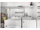 Laundry room equipped with a modern washer, dryer, and storage shelves at 11 Escondido Cir # 110, Altamonte Springs, FL 32701