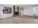 Living room with a brick fireplace, a sliding glass door to the screened in porch and neutral carpet at 11 Escondido Cir # 110, Altamonte Springs, FL 32701