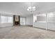 Open living room with neutral carpet, fireplace, window and a built-in bar at 11 Escondido Cir # 110, Altamonte Springs, FL 32701
