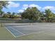 Outdoor tennis courts with full nets, green surfaces, and beautiful landscaping at 11 Escondido Cir # 110, Altamonte Springs, FL 32701