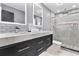 This modern bathroom has dual sinks and a large shower with matching tile for a contemporary style at 116 Alcala Dr, Kissimmee, FL 34758